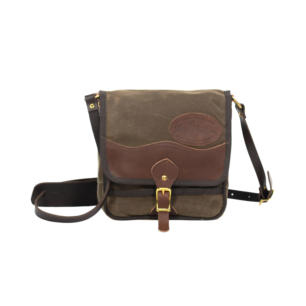 Timeless shoulder bag made from waxed canvas, premium leather, and solid brass.