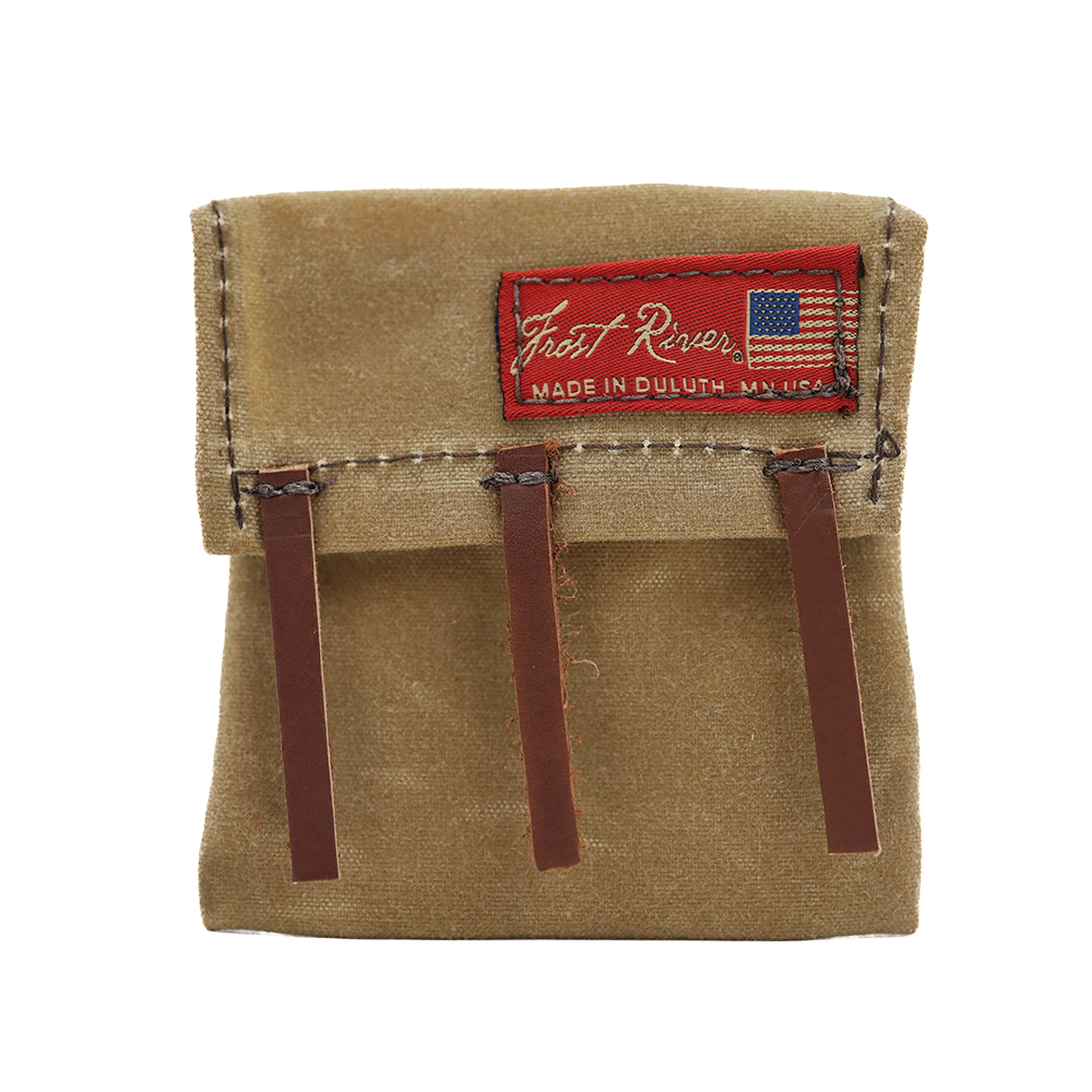 A beige mini canoe pack made of waxed canvas with brown leather straps and a red label that reads 'Frost River', 'Made in USA'.