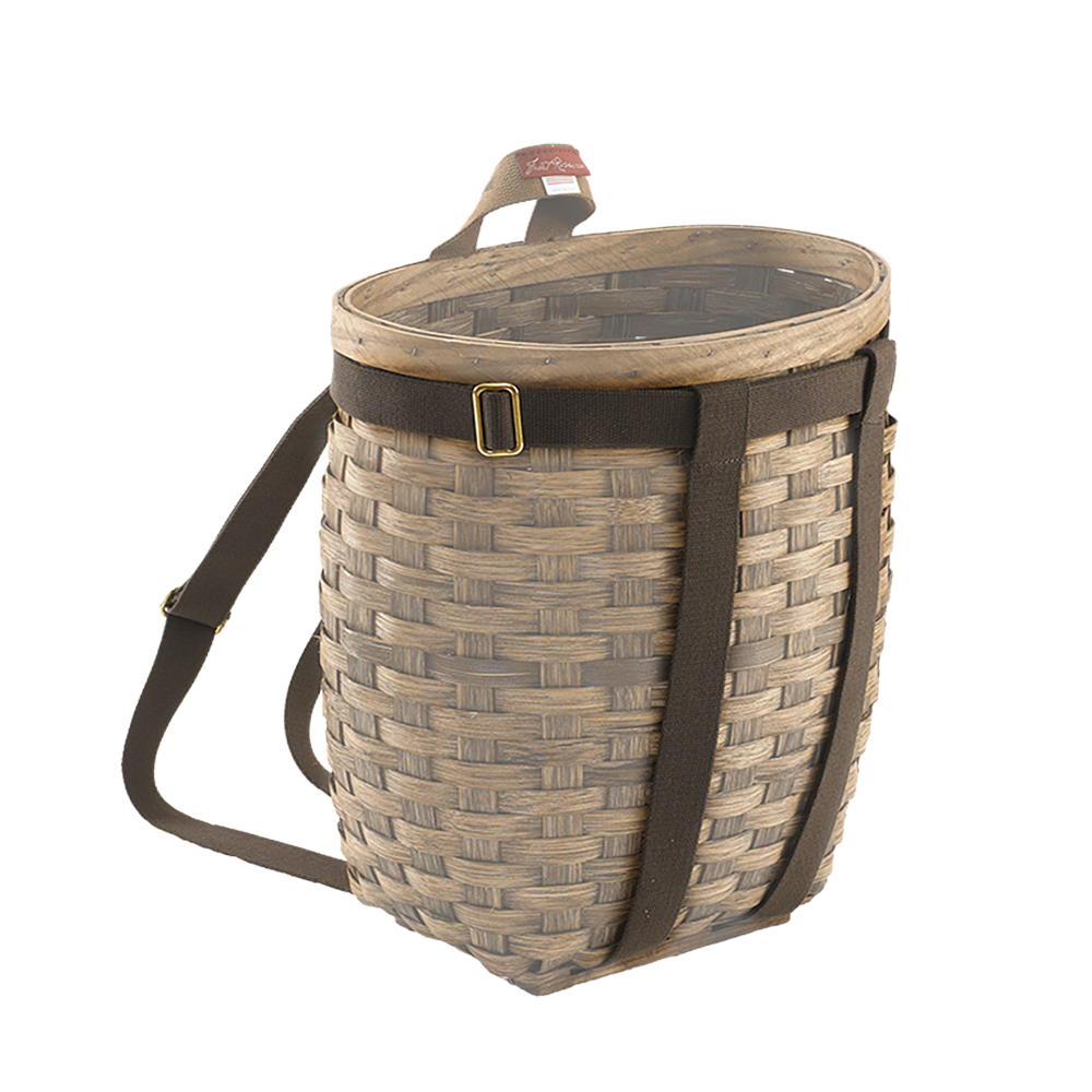 A traditional woven basket with a brown cotton web harness equipped with solid brass hardware.
