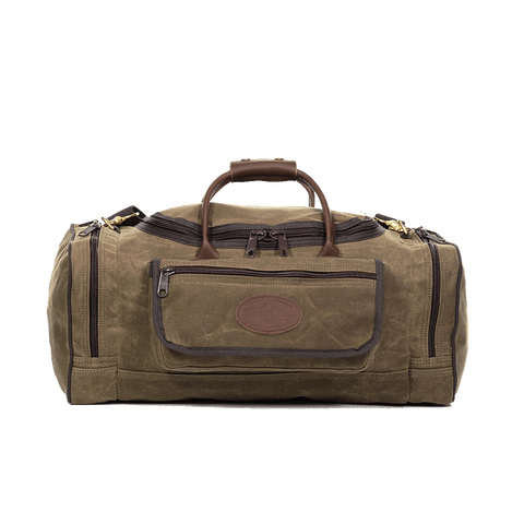 Waxed canvas luggage bag with large exterior pockets and leather handles