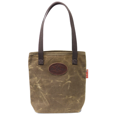 A waxed canvas tote bag with cotton web handles and a leather patch on the front.