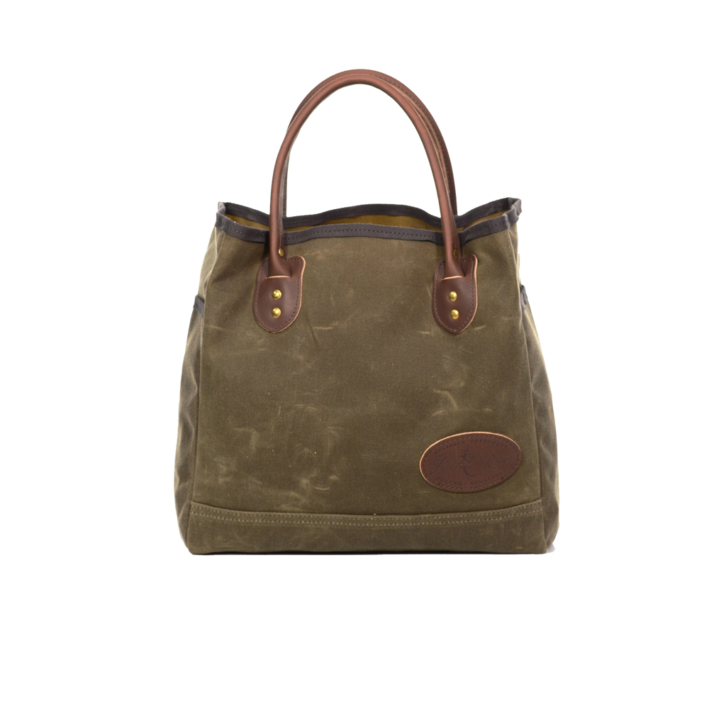 Waxed canvas tote with brown leather handles.
