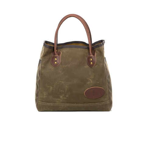 Waxed canvas tote with brown leather handles.