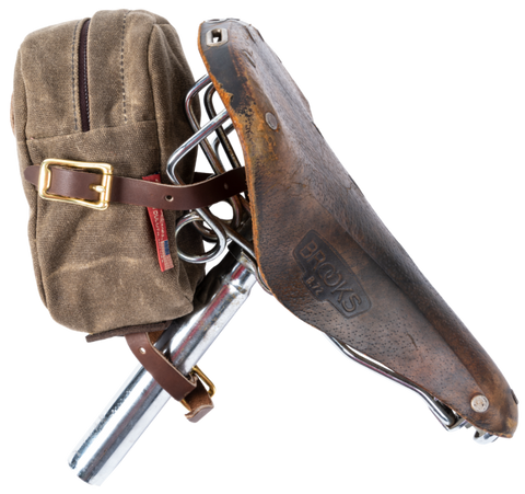 The bike bag opens from the back with a heavy duty coiled zipper and is made with water resistant waxed canvas.