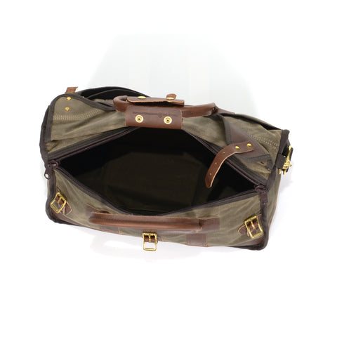 Luggage bag with zippered opening and premium leather grab handles.