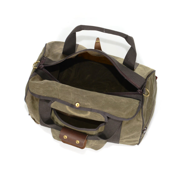 Duffle bag with large zippered opening, and a waxed canvas rain flap.
