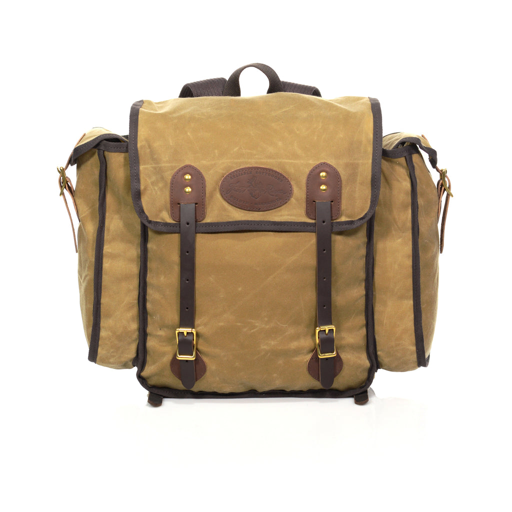 The Cliff Jacobson is a light weight tan colored box style pack. With two leather straps in the front to secure your load. Handcrafted in Duluth, MN.
