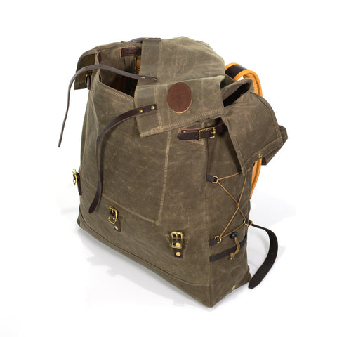 The top closure flap is made with three leather straps that secure to solid brass buckles at the lower portion of the pack.