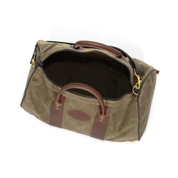 Waxed canvas duffle bag with a straight zippered opening.